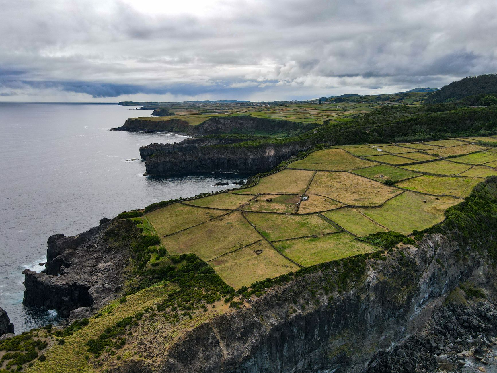 Whale watching boat off the coast of the Azores with tourists looking out to sea