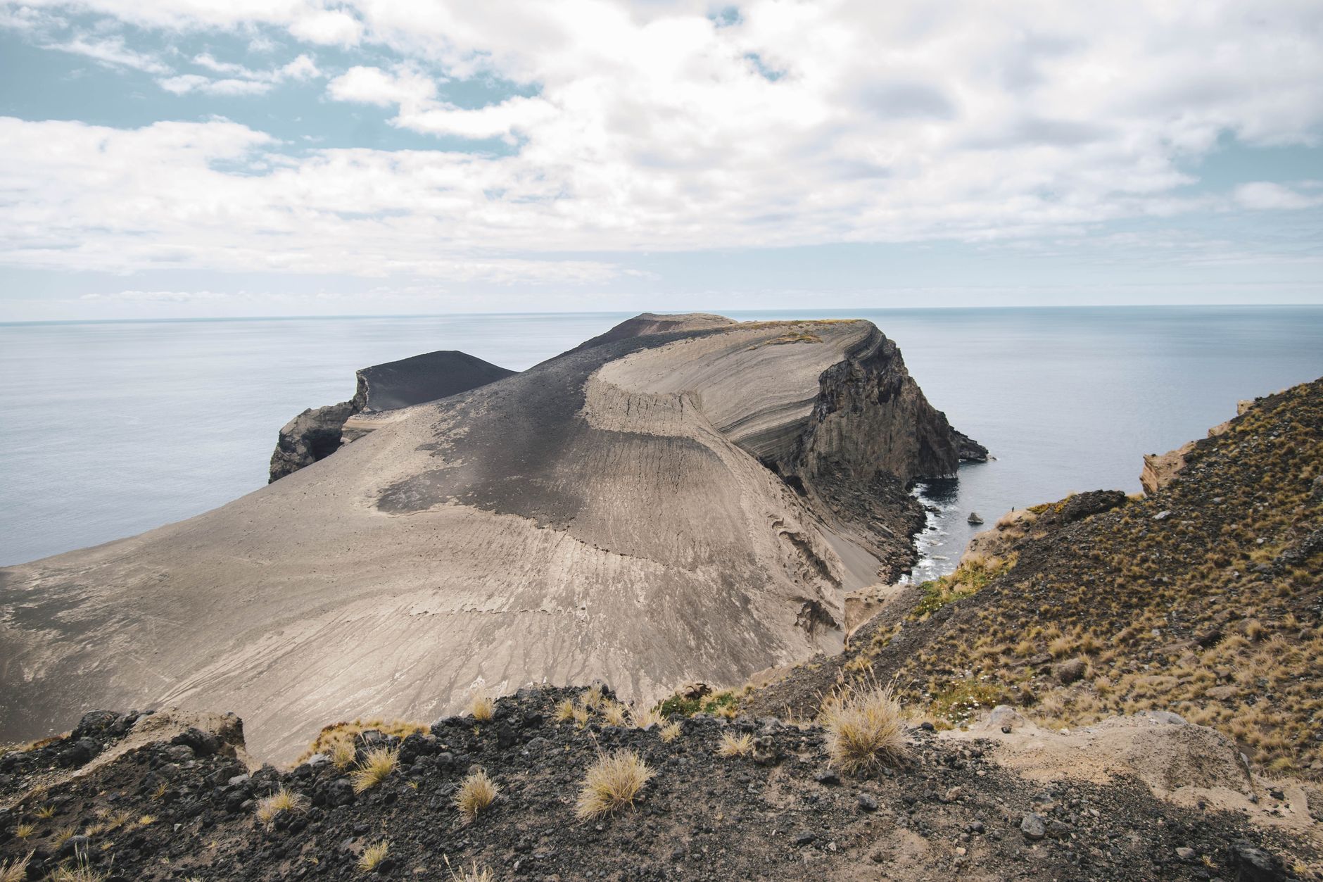 The volcanic landscape around Capelinhos on the western tip of Faial, with the sea beyond