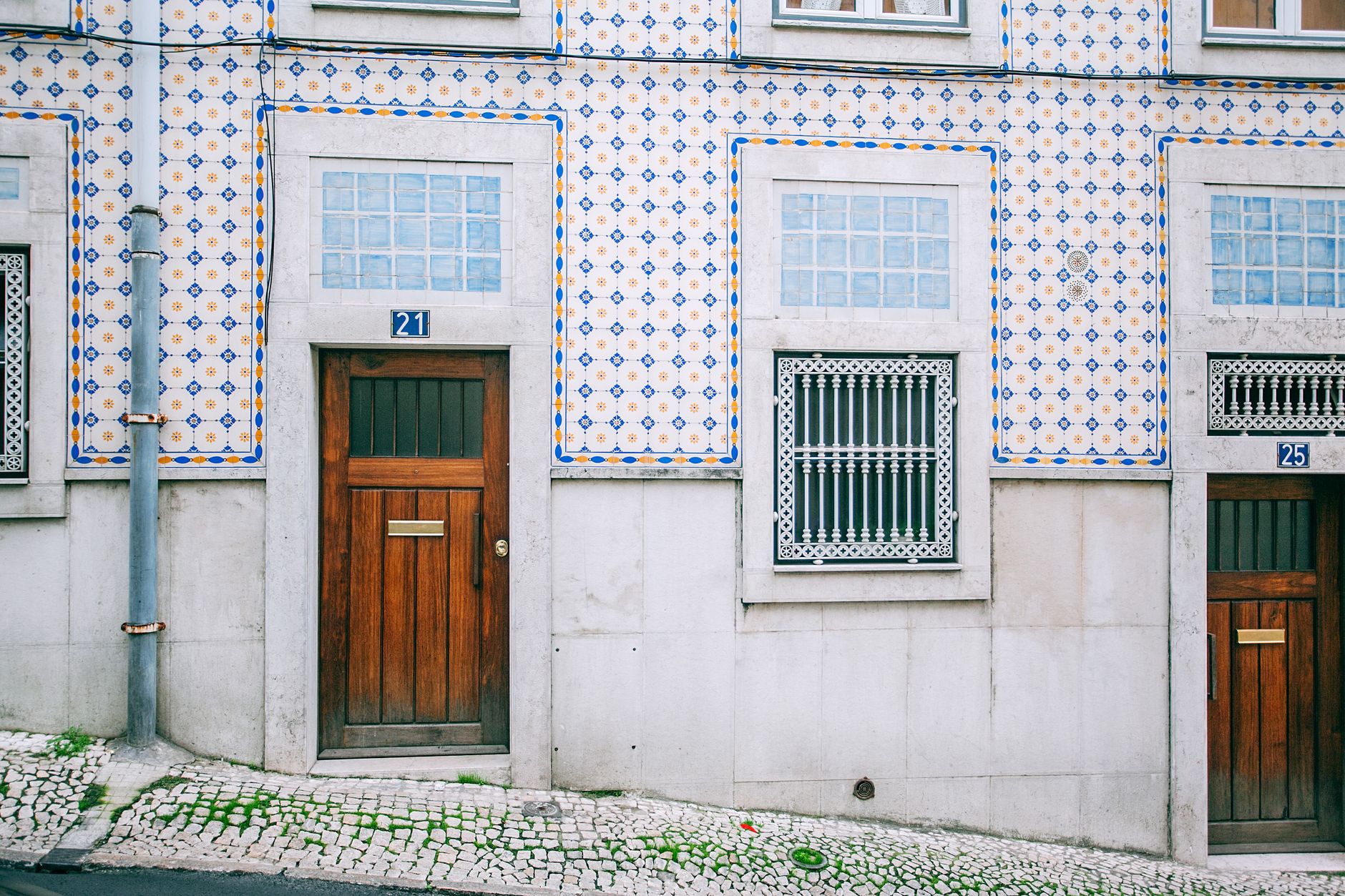The facade of a traditional Portuguese Conservatória building in a historic Azorean town.